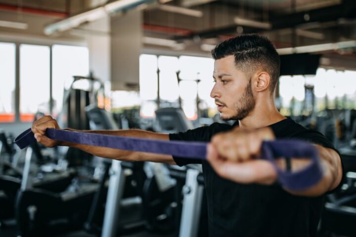 Man performing resistance band pull-apart