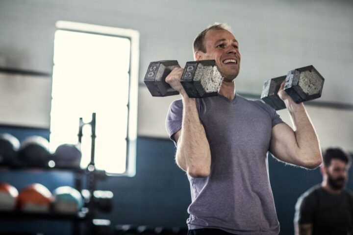 Man with dumbbells in front rack position