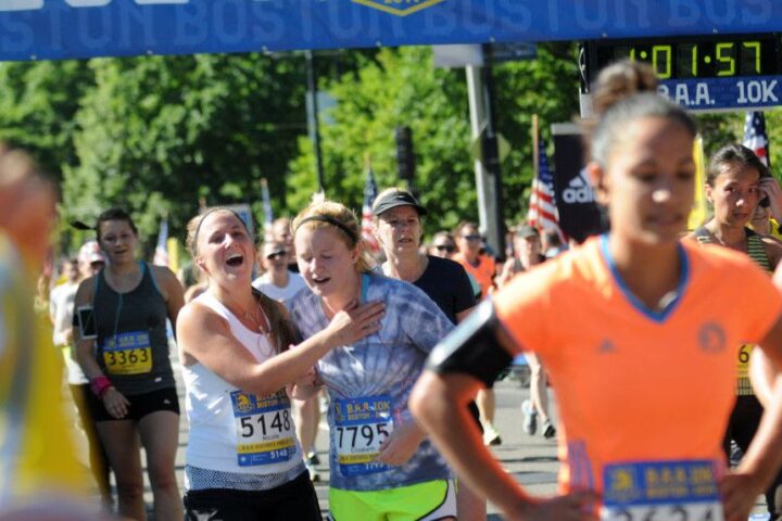 Runners cross the finish line at the B.A.A 10K. Sunday, June 22, 2014