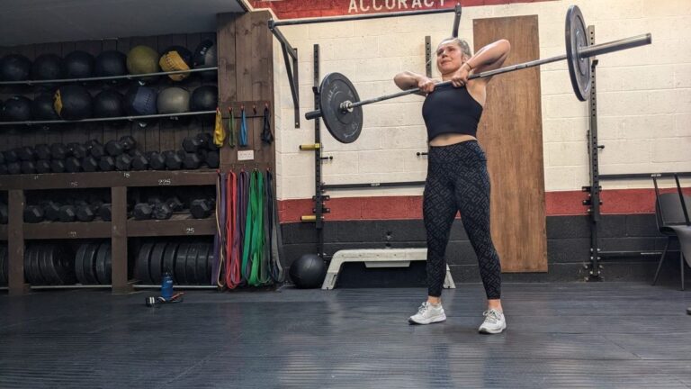 Emma Ray demonstrates the squat part of the barbell thruster