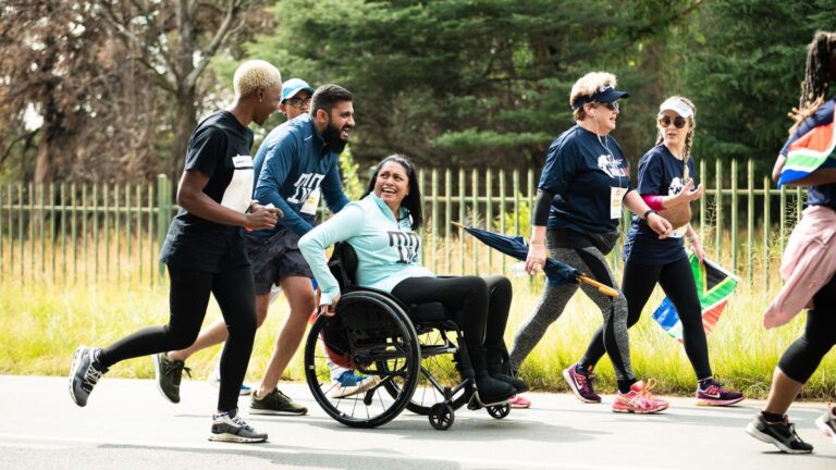 Runners and a wheelchair user take part in the Wings for Life World Run App Run in Johannesburg, South Africa, on May 7, 2023.