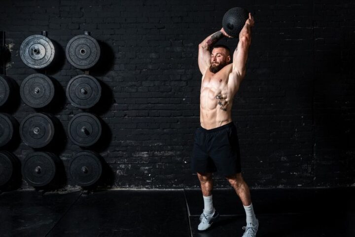 Man about to slam medicine ball into gym floor