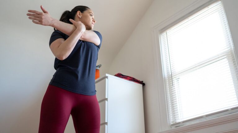 Woman stretches at home