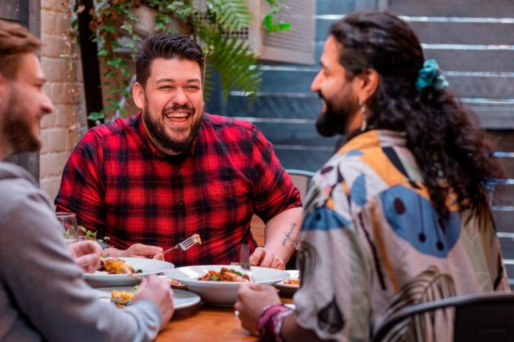 Group of happy friends eating restaurant