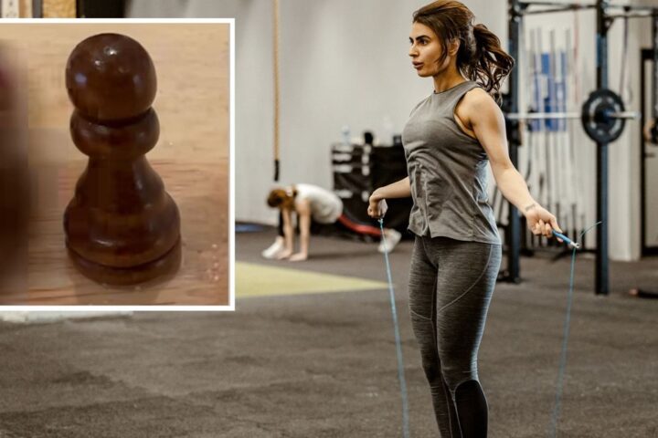 A woman performing double-unders in a CrossFit box, and Dave Castro